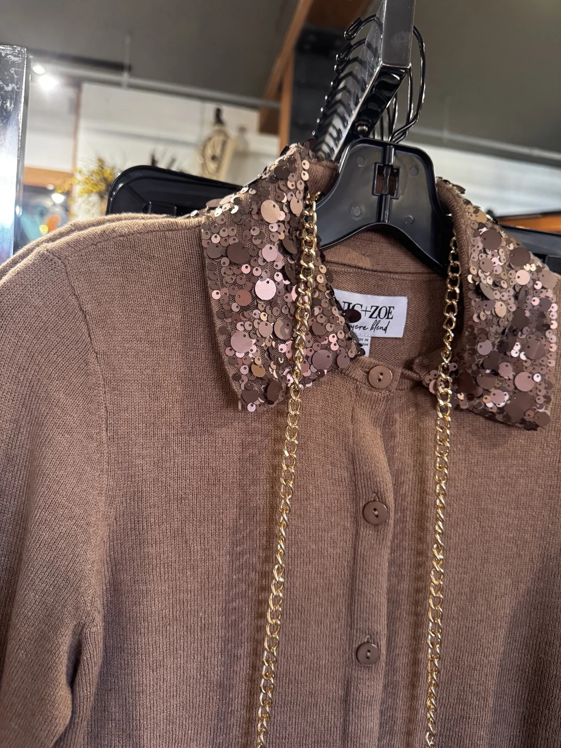 Warm bronze sequin detail on a knit sweater