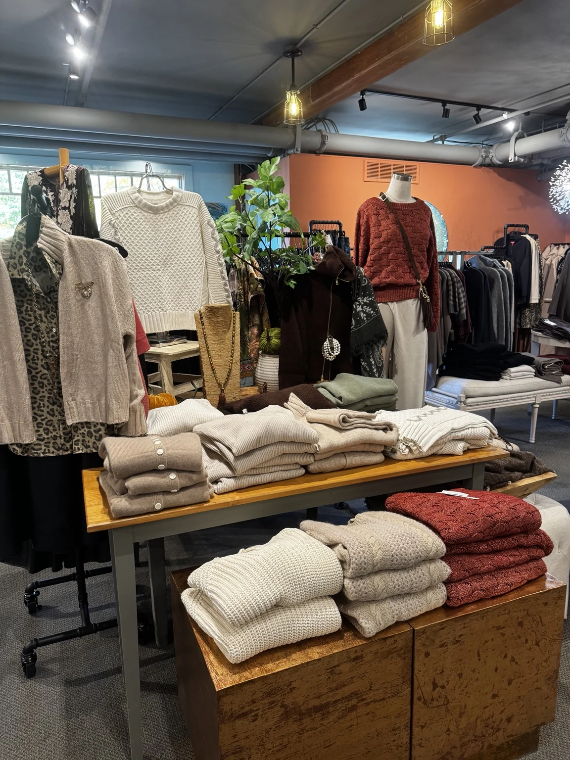 Folded sweaters and display tables inside the boutique